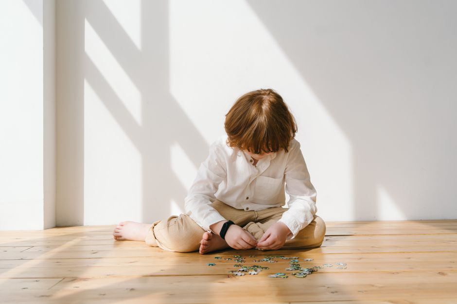 A child concentrating on a challenging puzzle