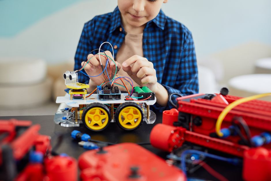A child building a robot from a kit