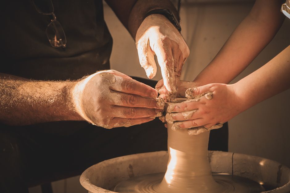 Hands shaping clay on a potter's wheel, a hands-on skill
